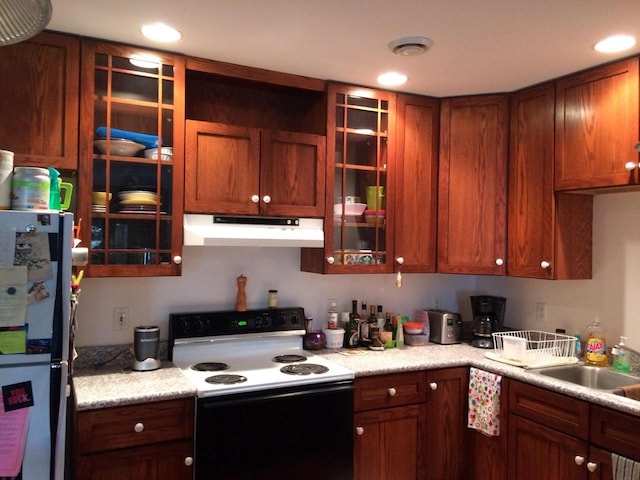 kitchen featuring white appliances and sink