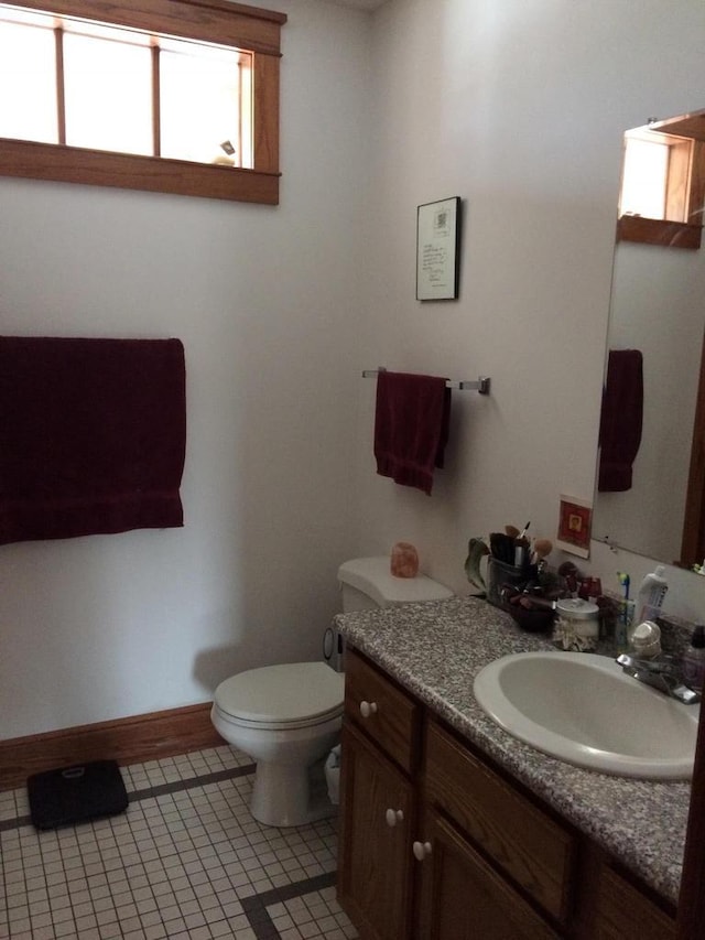 bathroom with tile patterned flooring, vanity, and toilet