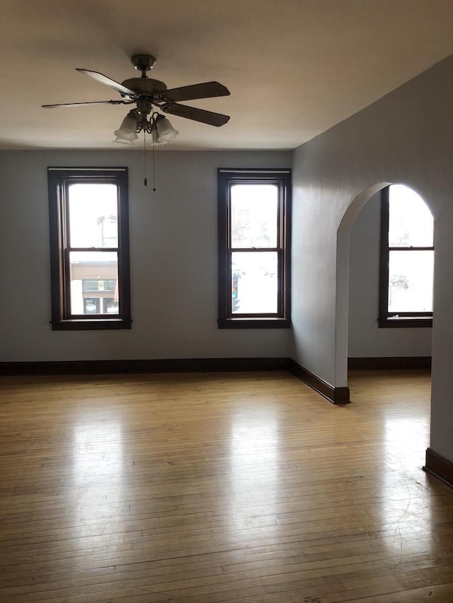 empty room featuring light wood-type flooring and ceiling fan