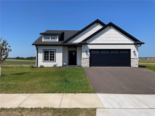 craftsman house featuring a garage and a front yard