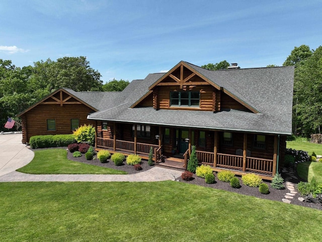 log cabin with a front lawn and a porch