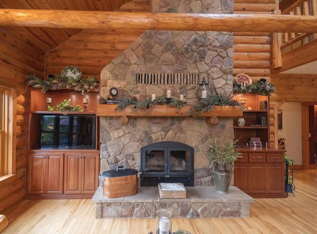 living room with log walls, wooden ceiling, a stone fireplace, high vaulted ceiling, and light hardwood / wood-style floors