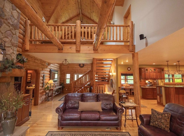 living room with a wealth of natural light, high vaulted ceiling, wooden ceiling, and light wood-type flooring