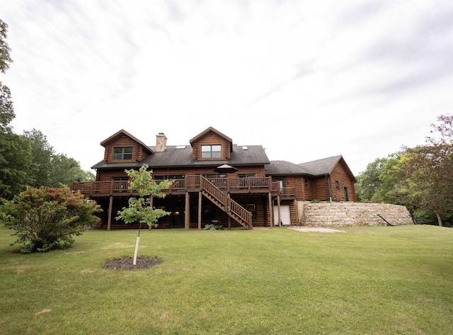 rear view of property featuring a yard and a deck