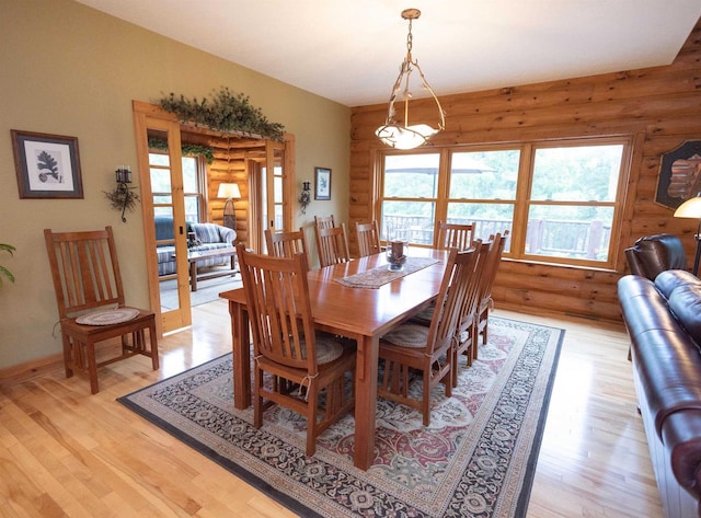 dining space with french doors and light hardwood / wood-style floors