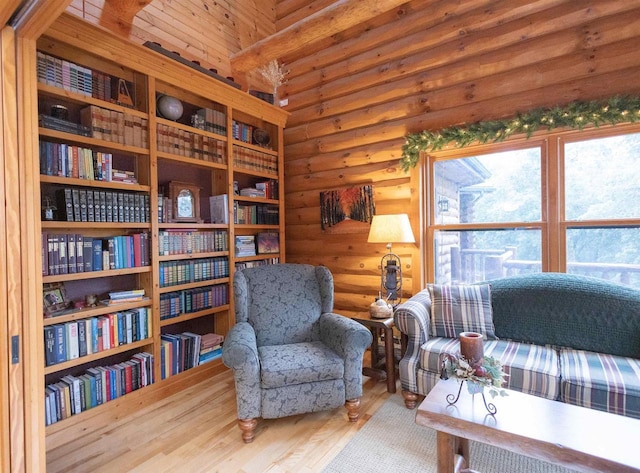 sitting room featuring hardwood / wood-style floors, log walls, and wooden ceiling