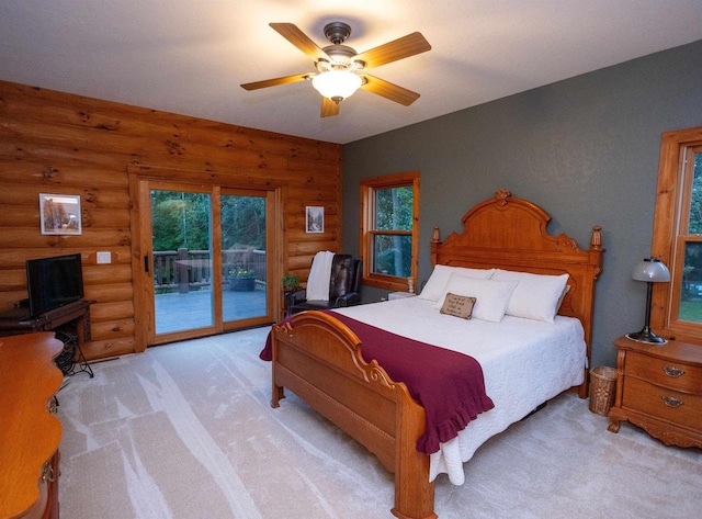 bedroom featuring ceiling fan, light carpet, access to outside, and log walls