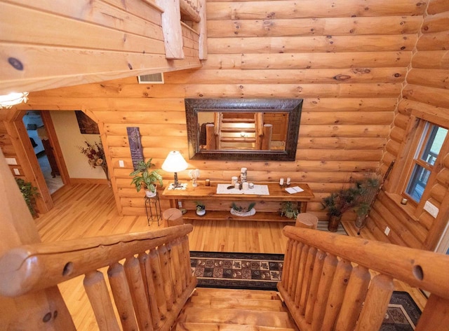 interior space featuring hardwood / wood-style flooring and rustic walls