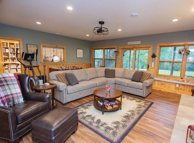 living room featuring hardwood / wood-style flooring and wooden walls