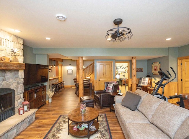 living room featuring ceiling fan and hardwood / wood-style floors