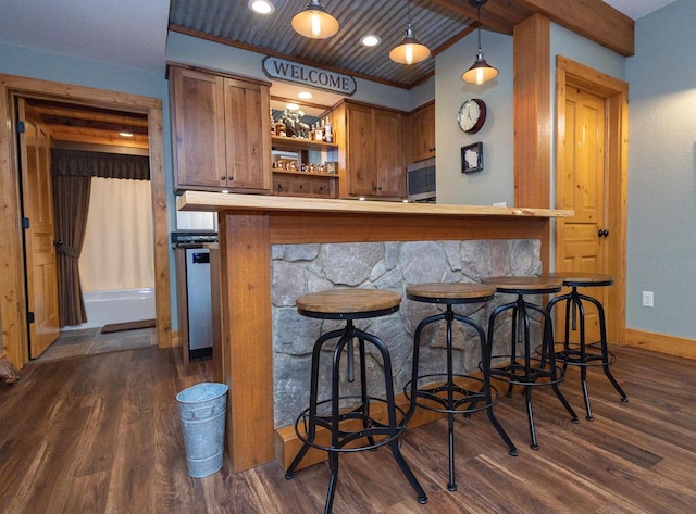 bar with beamed ceiling, decorative light fixtures, wooden ceiling, and dark wood-type flooring