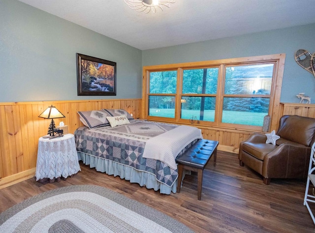 bedroom featuring wood walls and dark wood-type flooring