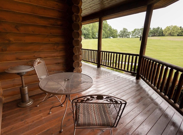 wooden deck featuring a yard