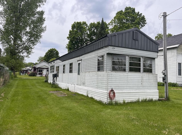 view of property exterior featuring a lawn