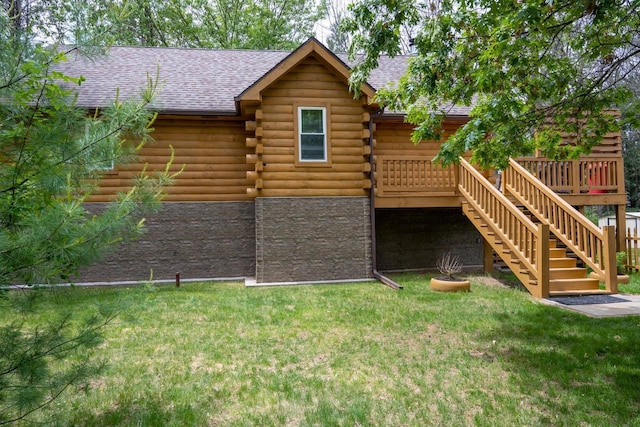 back of property with a yard and a wooden deck