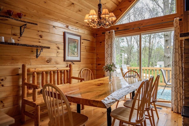 dining room with a chandelier, wooden ceiling, light hardwood / wood-style flooring, and vaulted ceiling