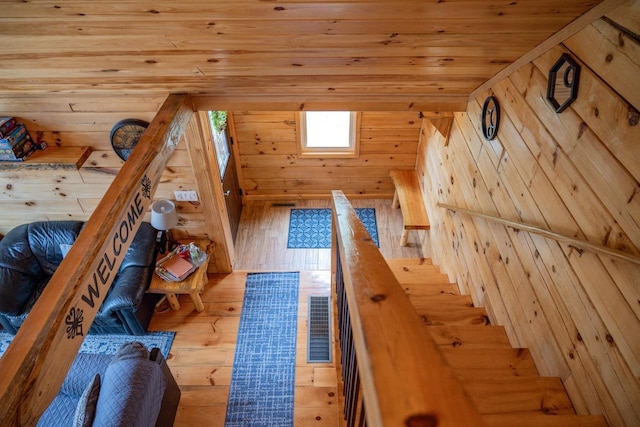 unfurnished bedroom featuring light hardwood / wood-style floors, wood ceiling, and wood walls