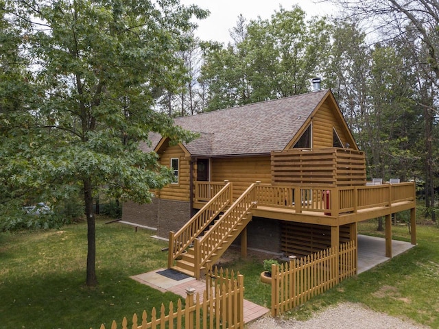 back of property featuring a yard and a deck