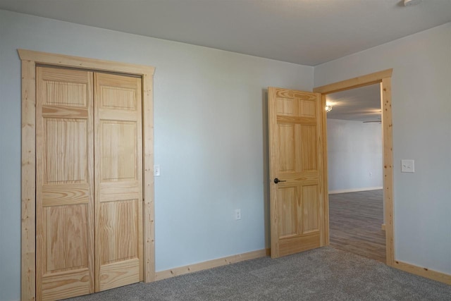 unfurnished bedroom with a closet and carpet