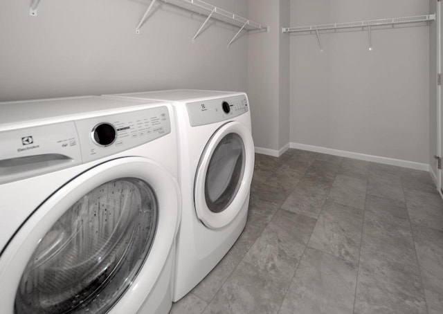 clothes washing area featuring washer and clothes dryer