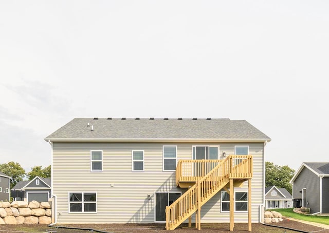 rear view of house featuring a wooden deck