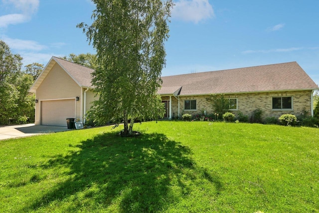 ranch-style home with a garage and a front lawn