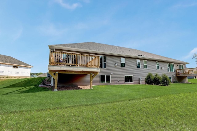 rear view of house featuring a wooden deck and a yard