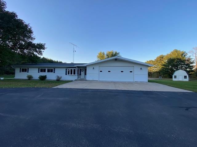 single story home featuring a garage and a front yard