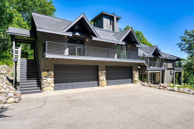 view of front of house featuring a balcony and a garage