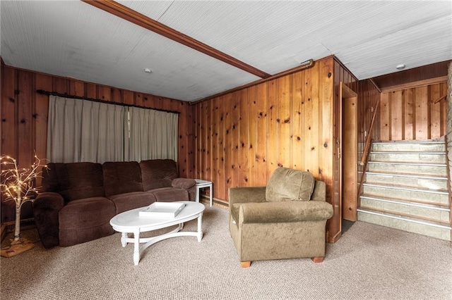 carpeted living room with wood walls