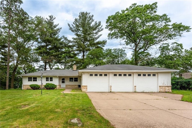 view of front of property with a front yard and a garage