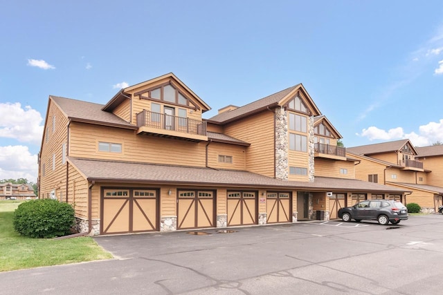 exterior space with a balcony and a garage