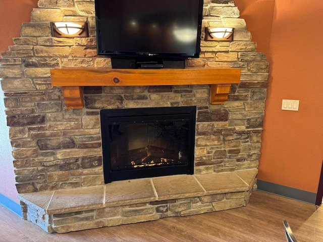 room details featuring a fireplace and wood-type flooring