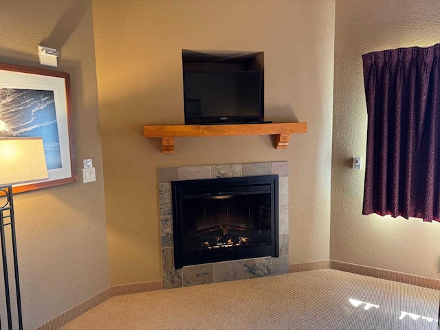 details with a tiled fireplace and carpet