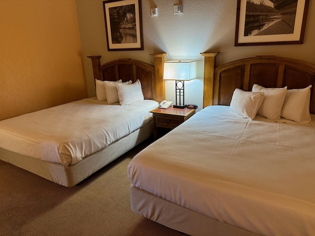 bedroom featuring carpet and a textured ceiling