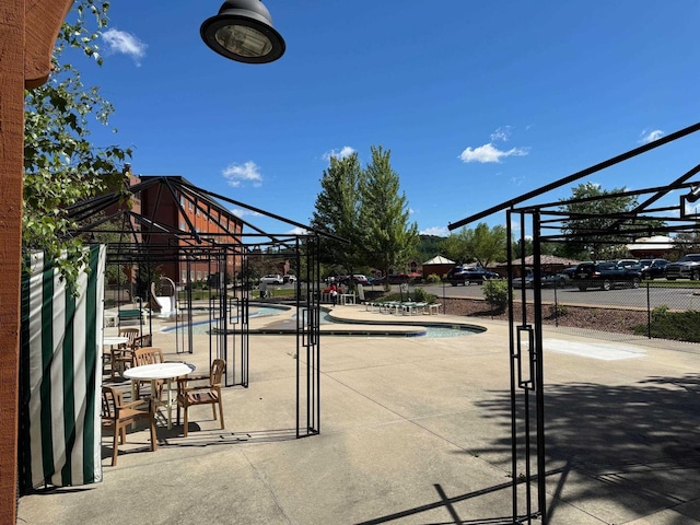 view of home's community featuring a pool and a patio area