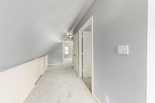 bonus room featuring light colored carpet and vaulted ceiling