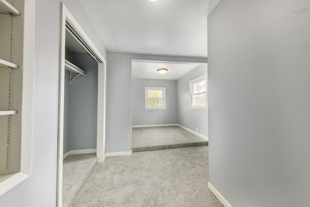 walk in closet with light colored carpet