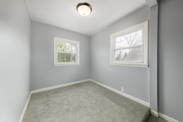 unfurnished room with carpet flooring and a healthy amount of sunlight