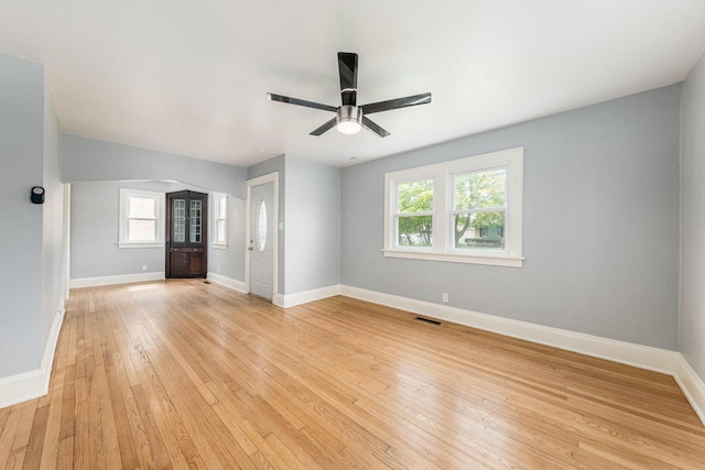 unfurnished living room featuring light hardwood / wood-style flooring, plenty of natural light, and ceiling fan