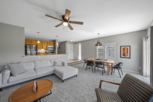 carpeted living room with ceiling fan