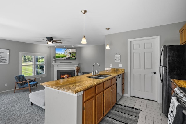 kitchen featuring ceiling fan, sink, stainless steel dishwasher, kitchen peninsula, and light colored carpet