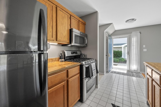 kitchen featuring light tile patterned floors and stainless steel appliances