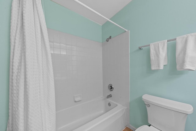 bathroom with toilet and shower / bathtub combination with curtain