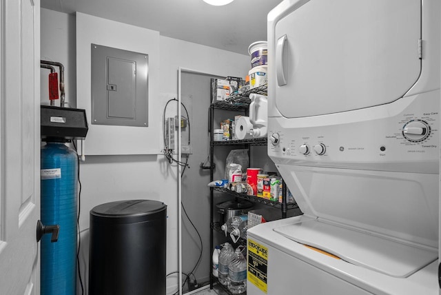 laundry room with electric panel and stacked washing maching and dryer