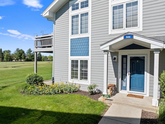 entrance to property with a lawn