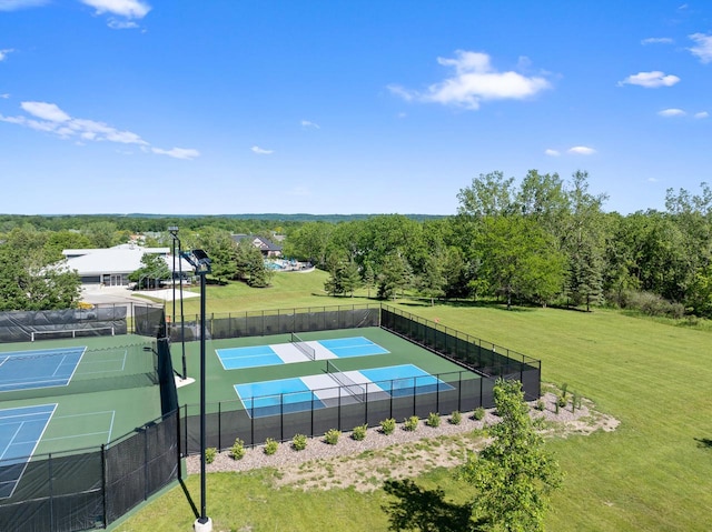 view of tennis court featuring a lawn