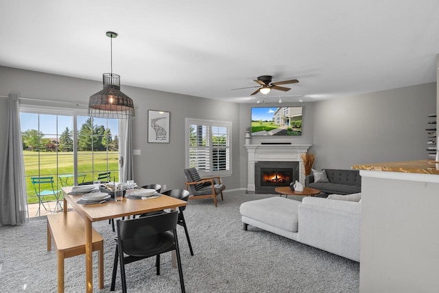 dining room featuring carpet flooring and ceiling fan