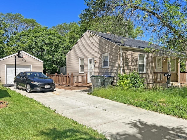 view of side of property with a garage, an outdoor structure, and a deck