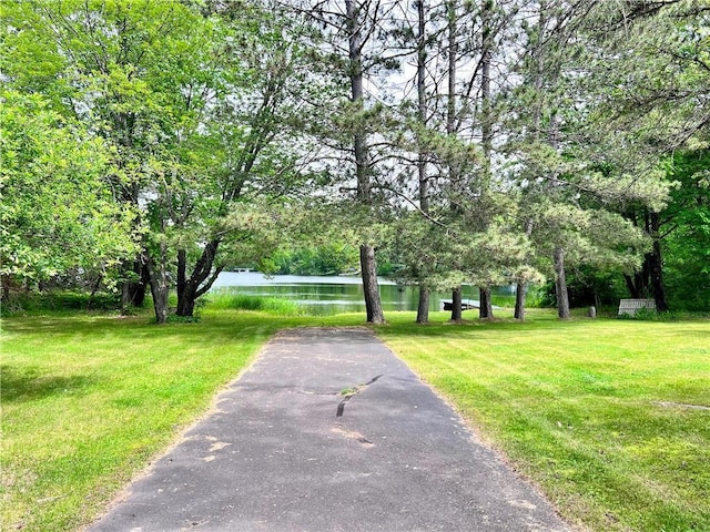 view of property's community featuring a yard and a water view